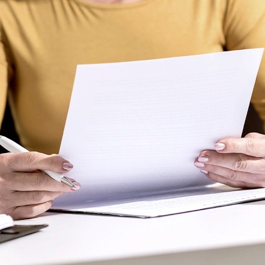 worker looking into a paper