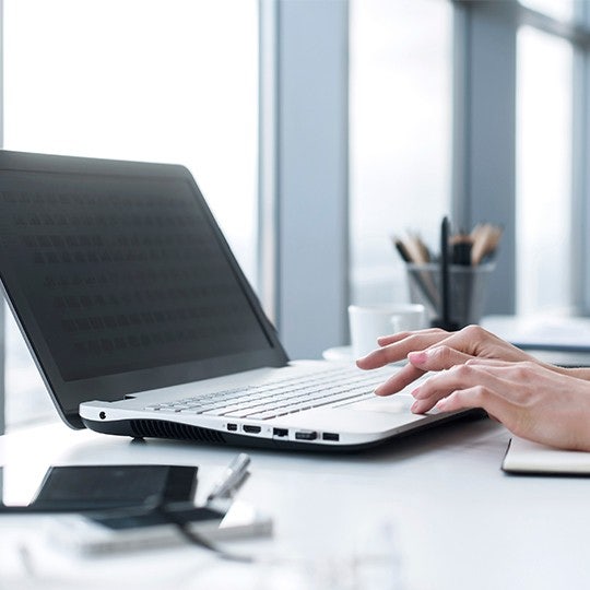 worker typing in a laptop