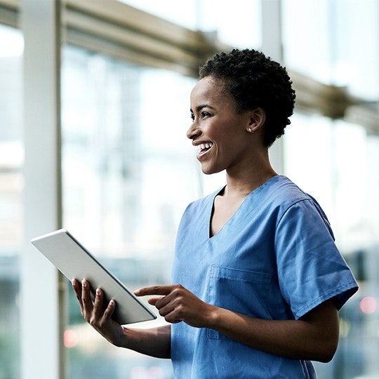 doctor looking into a tablet