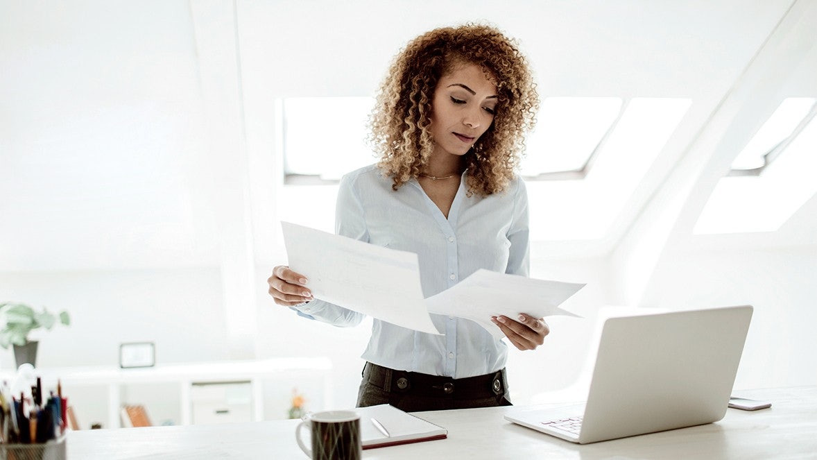 woman looking to papers