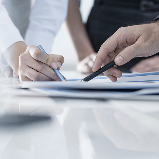 people pointing a paper 