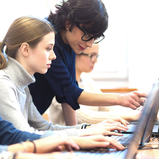 people looking into a screen