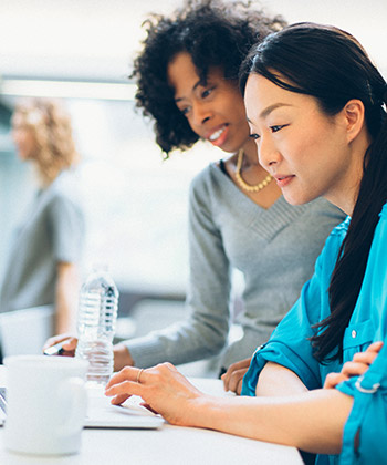 two female colleagues working together at a laptop