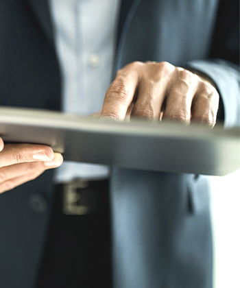 hands typing on a tablet