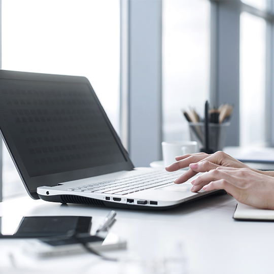 hands working on a laptop
