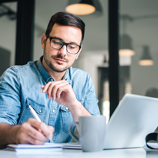 man typing in a laptop 