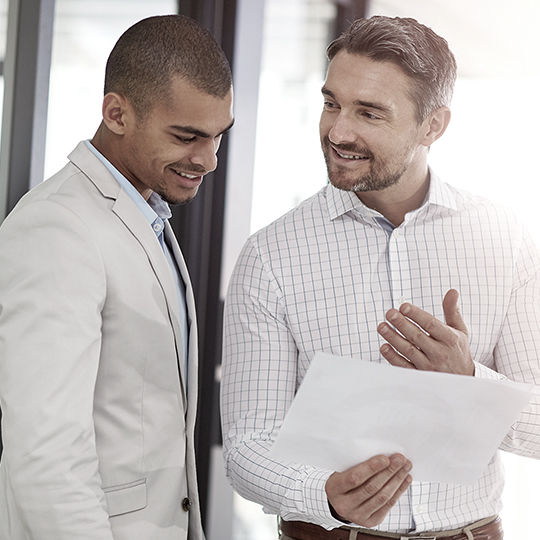 people talking holding papers