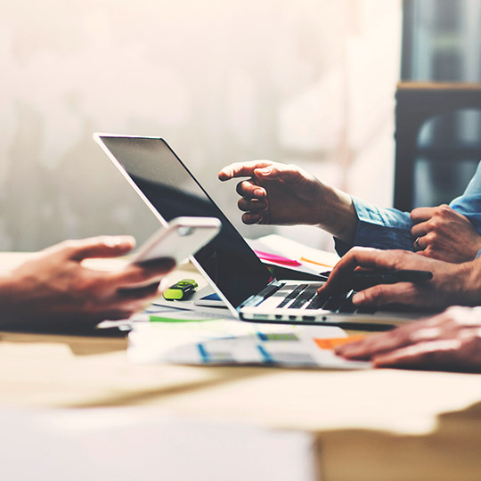 close up of two people working on a computer