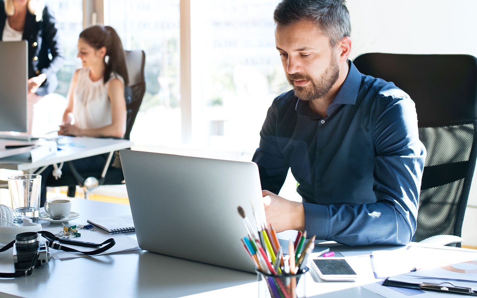 man working on laptop in office setting