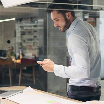 Printing and Enterprise Mobility man looking at mobile phone