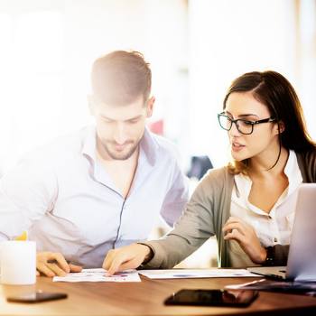 Check Your Warranty two colleagues working together