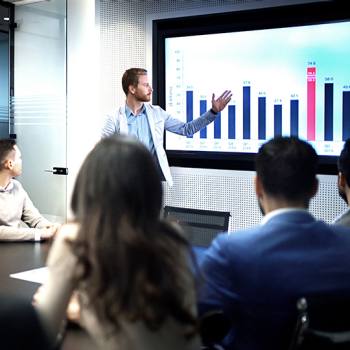 How digital platforms are rethinking business mode man showing a graph in a meeting
