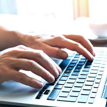 Online privacy statement Close up of hands typing on a laptop