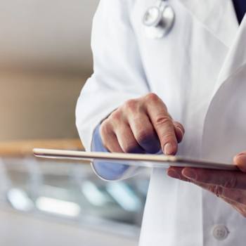 Navigate through Industries doctor holding a tablet