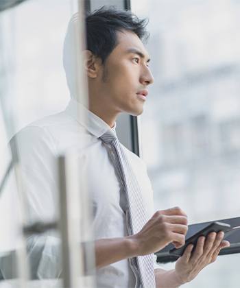 Business Managers and CFOs man looking through a window