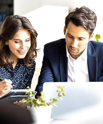 Streamline business with third parties two colleagues looking at a laptop