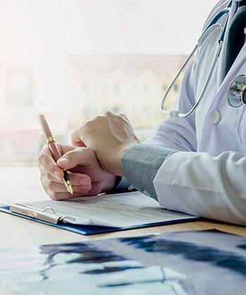 Ensure greater transparency  close up of doctor's hands writing