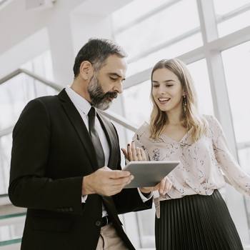 Discover Document Solutions for Departments people talking holding a tablet