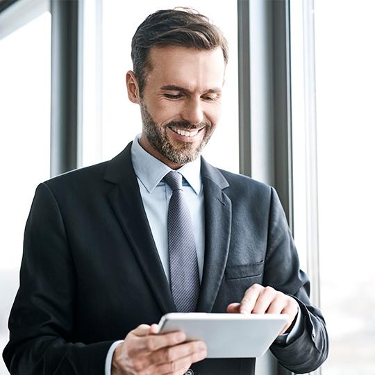 The link between mobility, happiness, and productivity man typing on a tablet