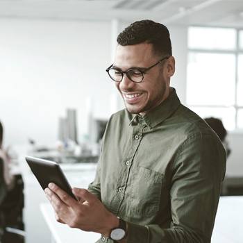 Paperless is key to digital transformation man looking into a tablet