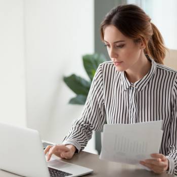 Resolve business opportunities swiftly using ECM woman typing in a laptop