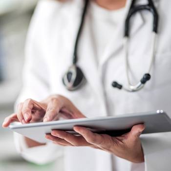Automating processes in the workplace doctor looking into a tablet