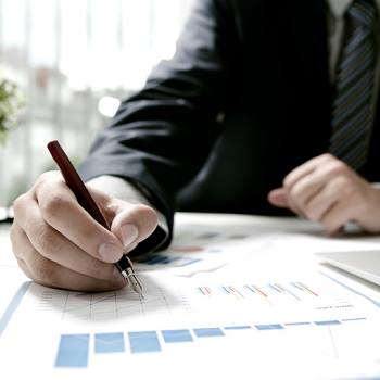 Achieving a positive ROI in Production Print man looking into some graphics