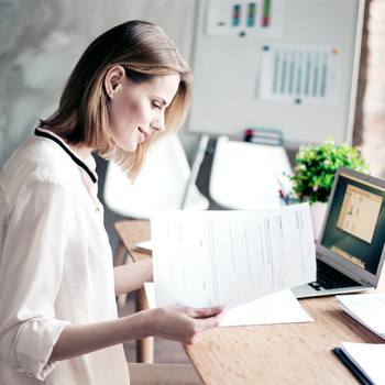 Finding ways of being sustainable with Inkjet woman looking into some papers